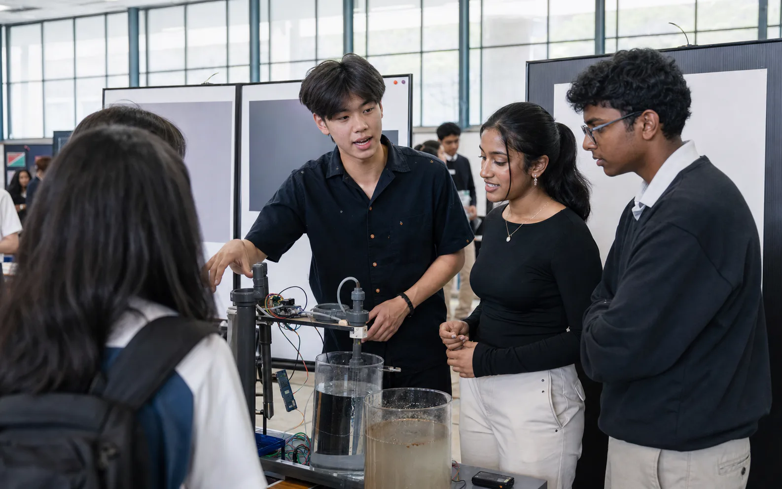Students presenting a water sensor project at Horizon's research exhibition